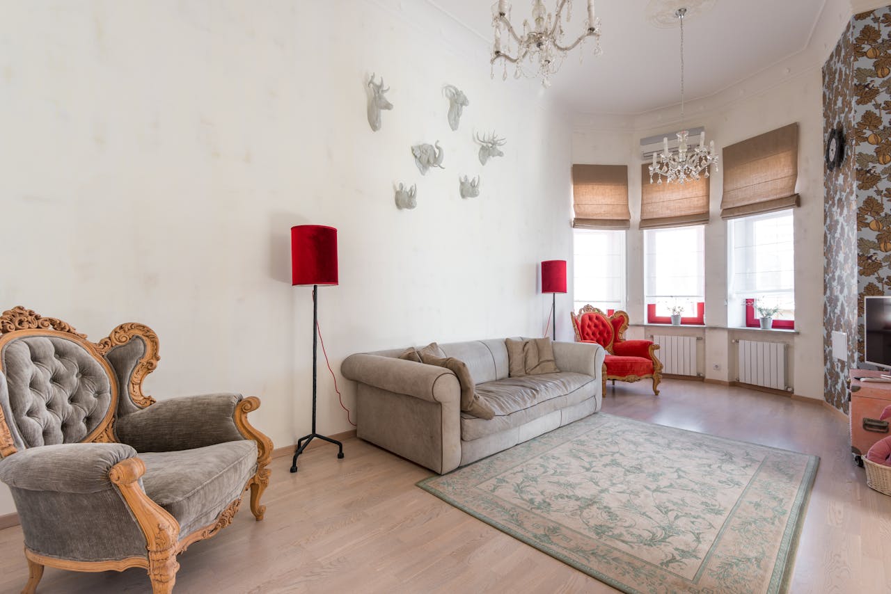 Spacious living room with vintage armchairs and elegant decor, ideal for interior design inspiration.